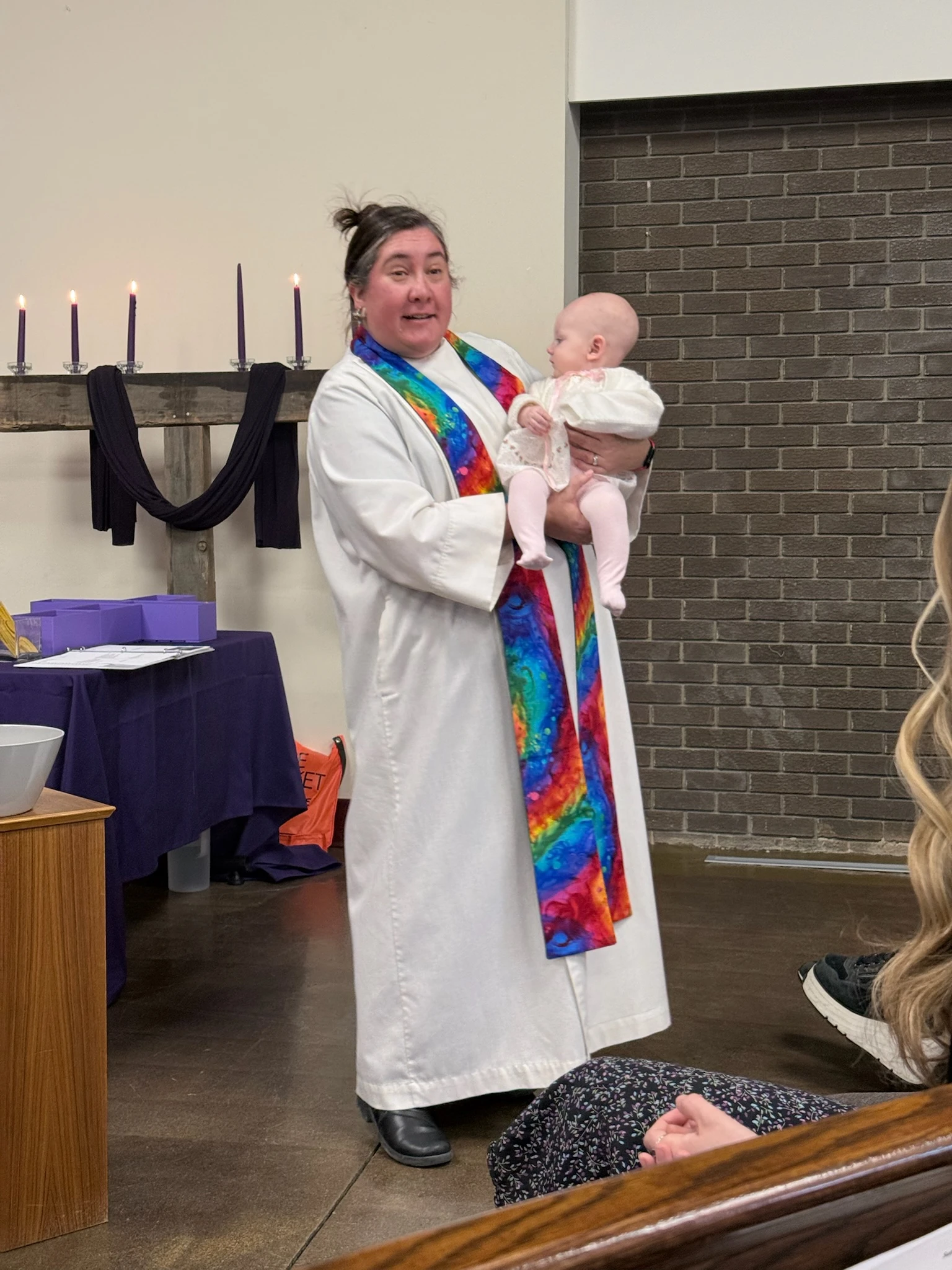 Pastor Liz holding baby Evelyn on her baptism